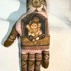 A beautifully detailed portrait of Lord Ganesha on the palm, perfect for bringing good fortune to any occasion. The dark, bold shading makes the design stand out.