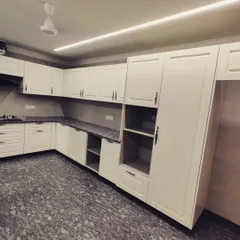 This view highlights the tall pantry and appliance unit, which integrates the refrigerator and provides floor-to-ceiling storage, maximizing the utility of the space.