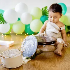 And... we have a flipped cake! The aftermath of a cake smash is often as fun as the beginning. This photo captures the hilarious reality of a one-year-old's encounter with his birthday cake.