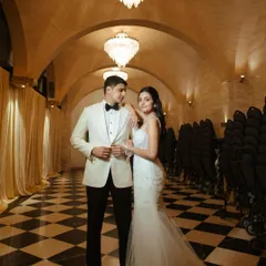The couple looking picture-perfect. Her timeless hairstyle works beautifully with the formal setting and elegant chandeliers.