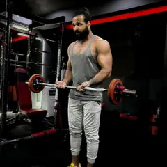 Make yourself a priority. An EZ bar curl in the squat rack, focusing on form to build bicep peaks.