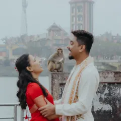 A spontaneous, joyful moment captured during a pre-wedding shoot in Haridwar, with an unexpected appearance by a local monkey adding a touch of humor and authenticity.