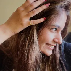 A happy client flaunting her new red and pink marble-effect nails. A great manicure is the best accessory.