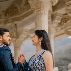 A close up shot capturing an intimate moment between the couple inside a carved marble pavilion. This photo focuses on their connection and the fine details of the bride's attire and jewelry.