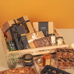 Our grand festive hamper, presented in a reusable wooden crate, is designed for generous gifting. It’s brimming with a curated selection of our finest products, including an almond tea cake, modern Indian sweets, basil pesto, and other gourmet jars, making it a truly impressive and memorable gift.