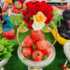 Fresh fruits and flowers bring so much life to a celebration. Here is an example of an artfully arranged fruit basket with pomegranates and fresh roses, designed to be both a beautiful centerpiece and a blessed offering.