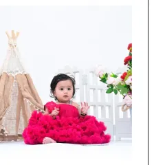 Another simple and elegant portrait against a white backdrop. The baby's curious gaze and the simplicity of the scene create a timeless and beautiful image.