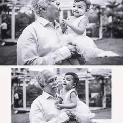 The pure joy shared between a grandfather and his baby granddaughter, captured in a classic black and white portrait.