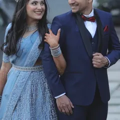 A happy couple at their reception. For the bride, I created a soft glam look with a shimmering silver-blue lehenga, diamond jewellery, and a half-up hairstyle that feels both modern and romantic.