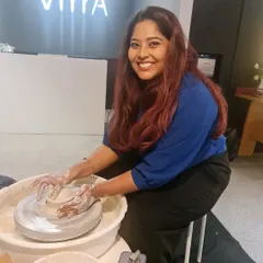 The joy of creating something with your own hands is universal. Here is a happy participant at the wheel during our Women's Day workshop, fully immersed in the pottery experience.