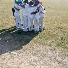Another angle of our team huddle, showing the unity and focus before taking the field. We emphasize that every player has a role to play in the team's success.