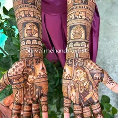 This design showcases realistic portraits of the bride and groom on each palm. The artwork extends up the arms with traditional motifs, including auspicious elephants and a sacred kalash.