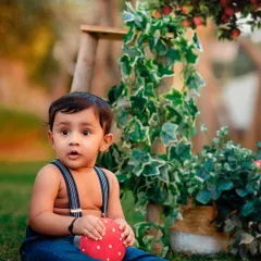 A curious expression captured during an outdoor toddler session. The props and natural setting provide a beautiful backdrop for capturing their budding personality.