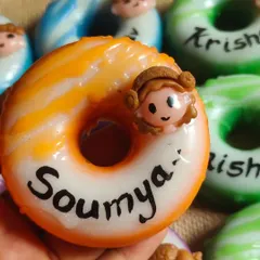 My personalized donut soaps are a huge hit for birthday return favors. This close-up shows a custom goat milk soap with the name "Soumya," handcrafted to be a sweet and memorable party gift.