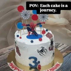 A dynamic Spider-Man cake for a 3rd birthday. This design features the web-slinger in action, complete with spider webs and city-themed toppers.