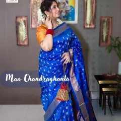 A stunning royal blue saree for Maa Chandraghanta on Day 3 of our Navratri series. This full-length portrait showcases the saree's drape and the traditional accessories, set against a decorated wall to add a touch of home and context.
