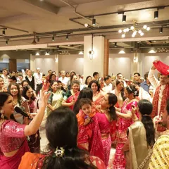 Leading the family in a traditional ceremony. My role is to facilitate these rituals smoothly while maintaining a celebratory and respectful atmosphere.