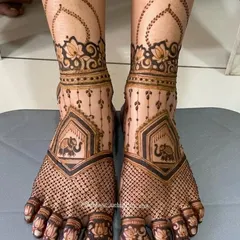 This delicate bridal feet design features a net pattern across the foot, with a small elephant motif and lotus details on the toes.