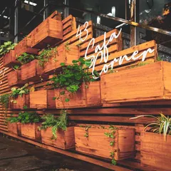 A key feature of the juicery's exterior is this large planter wall made of wooden slats and boxes. It adds a natural, biophilic element that reinforces the brand's focus on fresh ingredients.