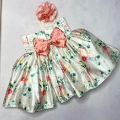 Our "Floral Grace" dress is a picture of classic charm. This version features a beautiful satin floral print with a large, matching bow at the waist.