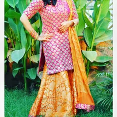 For festive occasions like Diwali, I design vibrant traditional wear like this sharara suit. This outfit features a pink brocade kurta paired with a contrasting orange brocade sharara and a matching dupatta, making it a complete and celebratory ensemble.