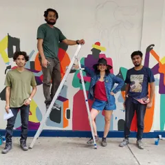 Team Berserk on site, taking a moment to pose during the creation of a colorful mural.