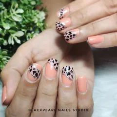 A stylish safari on your nails, this design pairs a nude polish with an animal print accent. It's a chic and trendy way to incorporate a wild pattern into your look.