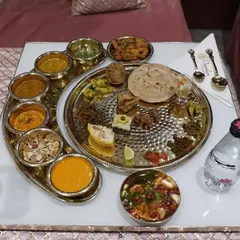 A feast for the eyes and the soul. This is our traditional Rajasthani thali, a complete culinary journey served with authentic flair and premium silver-plated tableware.