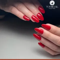 A flawless set of long, almond-shaped nails painted in a vibrant, classic red. This is a powerful and elegant statement look that never goes out of style.