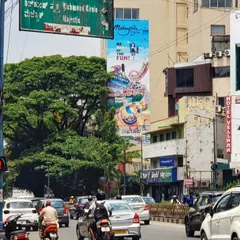 A view of the theme park mural from across the street, showing its impressive scale in the middle of city traffic.