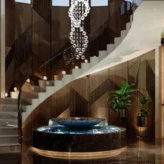 A beautiful stairway enhances the grandeur of any space. This helical staircase with a cascading crystal chandelier and a central water feature creates a dramatic and unforgettable architectural moment in this Agra residence.