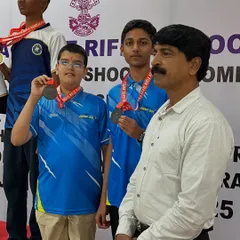 Young medalists on the podium with their coach after a successful competition.