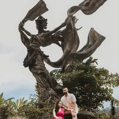 A majestic portrait in Bali's Taman Dedari, where the couple's vibrant outfits contrast beautifully with the ancient, towering statues. This image showcases our skill in composing grand, legendary-style pre-wedding photos.