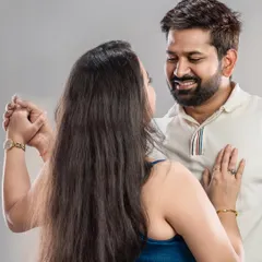 This photo captures the joy of a couple dancing together in the studio. It's a simple, happy moment that tells a story of their connection, perfect for celebrating a milestone.