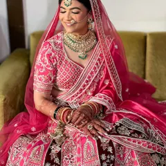 A candid moment of happiness. Her traditional updo is designed to perfectly support her dupatta and maang tikka.