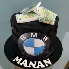 A bold statement cake for a BMW enthusiast, this design features the iconic logo and is topped with edible stacks of Euro notes. It's a fun and luxurious theme for a milestone birthday.