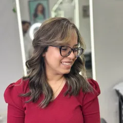 The client is all smiles with her new smoke blonde highlights. This look is effortlessly chic, with the cool tones framing her face and brightening her overall style.