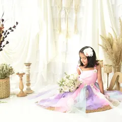 A dreamy and ethereal portrait for a fifth birthday. The pastel rainbow dress and soft, bright background give this photo a magical feel.