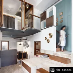 The "Grilled Sandwich House" features two duplex units stacked together. This interior shot shows the split-level design, which creates interesting volumes and visual connections between different living areas.