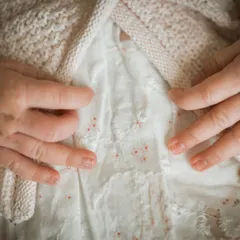 A macro shot focusing on the tiny, delicate hands of a newborn. These detail shots are a beautiful way to remember just how small they once were.