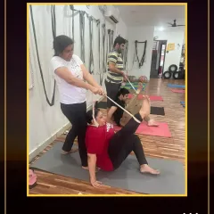 Using a strap in partner yoga allows for a controlled and deep stretch. It's a great example of how we work together in our community.