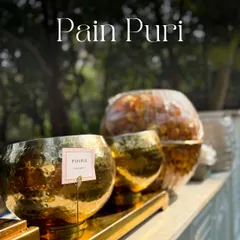 A close-up of the Pani Puri station, showcasing the gleaming brass bowls and neatly arranged puris. It’s the small details that elevate a simple street food into a luxury experience.