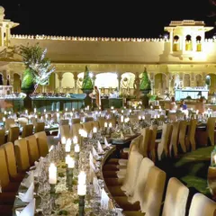 The welcome dinner at The Oberoi Udaivilas was a night of regal elegance. I designed the dining area with long, curved tables adorned with hundreds of candles to create a warm, intimate glow against the palace's stunning architecture.