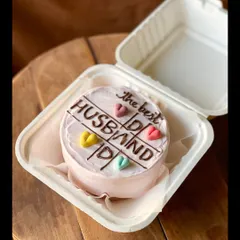 A sweet cake for "the best HUSBAND," designed with a tic-tac-toe theme and colorful hearts. It's a playful way to show your love and appreciation.