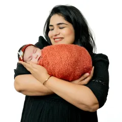 The bond between a mother and her newborn is pure magic. This portrait captures the mother's loving smile as she cradles her sleeping baby, a memory to hold onto forever.