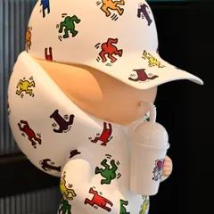 A detail of the 'Kid Cup (Keith Haring)' version. The faceless figure is covered in the artist's iconic dancing motifs, representing a playful and optimistic inner child.