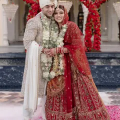 A classic portrait of Shikha and Rupen, their regal attire complementing the grandeur of their palace wedding.