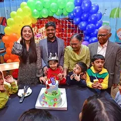 A happy family photo around the birthday cake. We provide the perfect backdrop for these cherished memories.