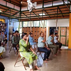 Participants at a corporate workshop for Health Heal practice a seated breathing technique. Learning to control the breath is a powerful tool for managing stress during a busy workday.