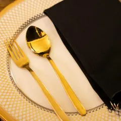 A close-up of a place setting featuring our gold-plated cutlery and fine china. These small details contribute to the overall sense of luxury and thoughtfulness that we bring to every table.